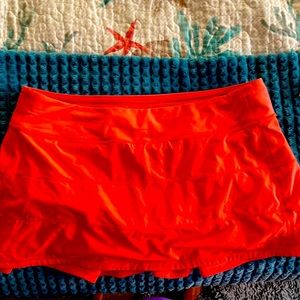 Coral pleated skirt with built in shorts and zippered stash pocket